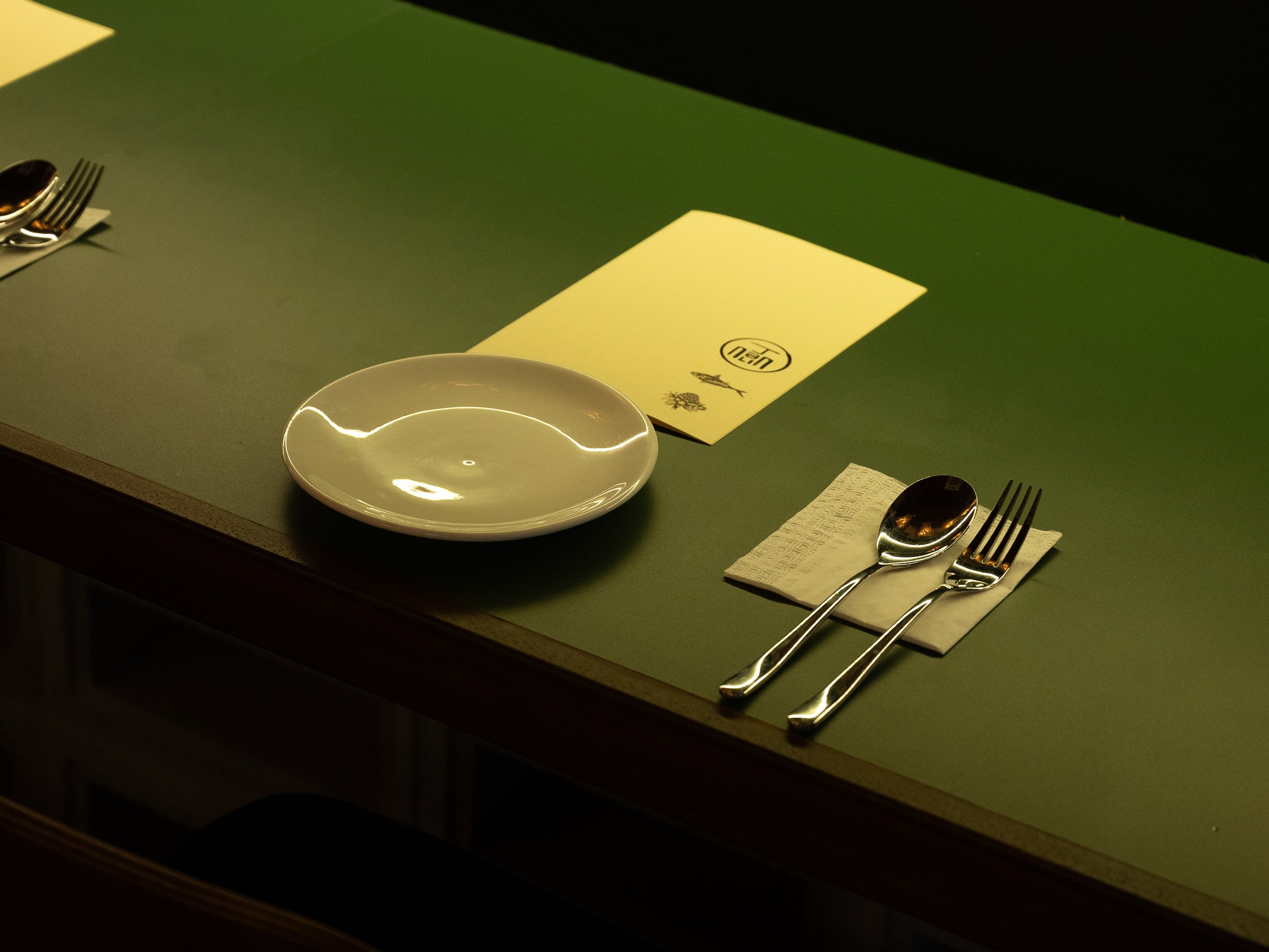 Dining room with green banquette seating